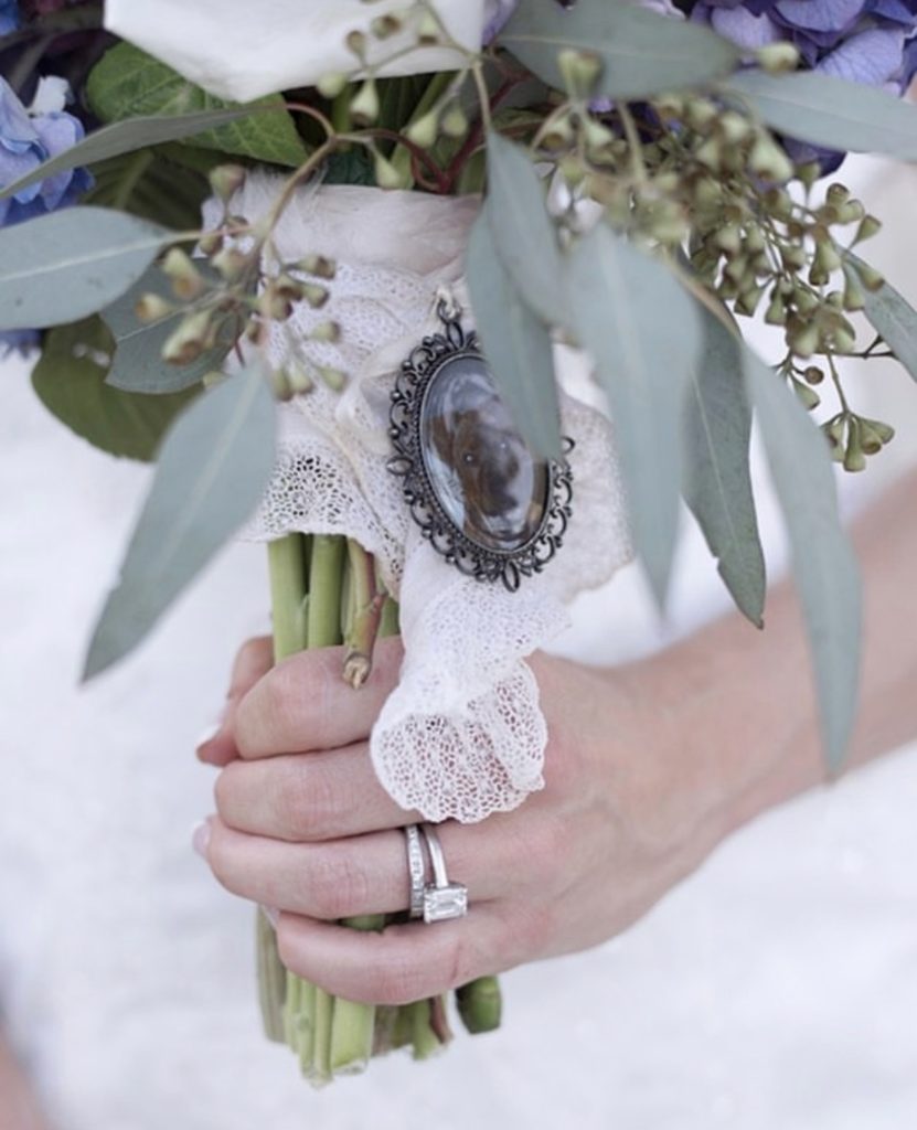 hand holding bouquet of white flowers with fresh greenery, outer banks wedding flowers, obx wedding flowers