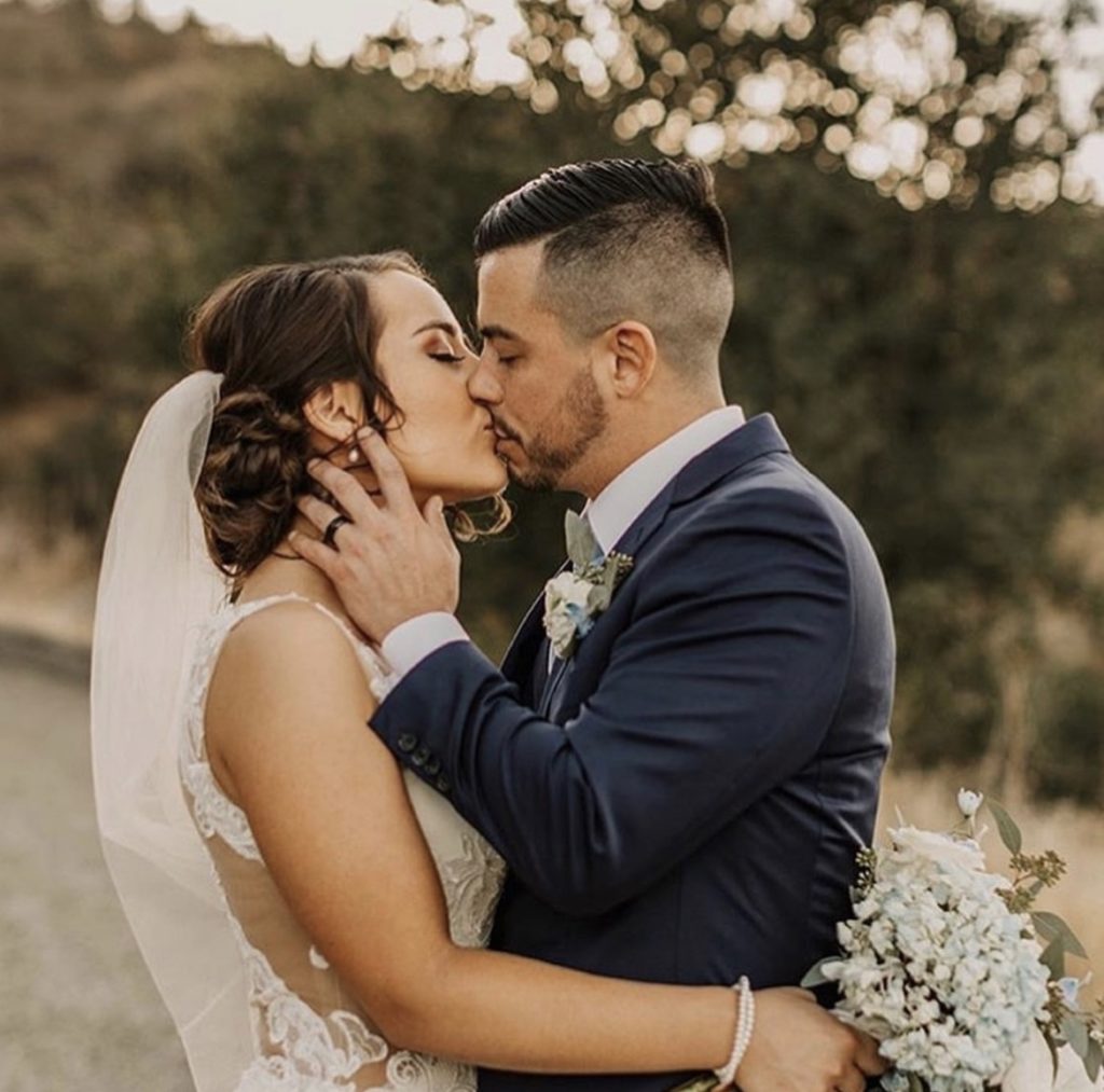 couple embraced at outer banks wedding, outer banks wedding flowers, obx wedding flowers