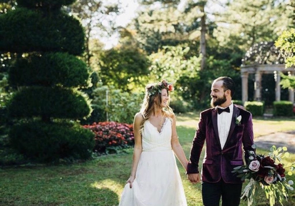 walking couple maroon tuxedo white dress bride obx wedding flowers