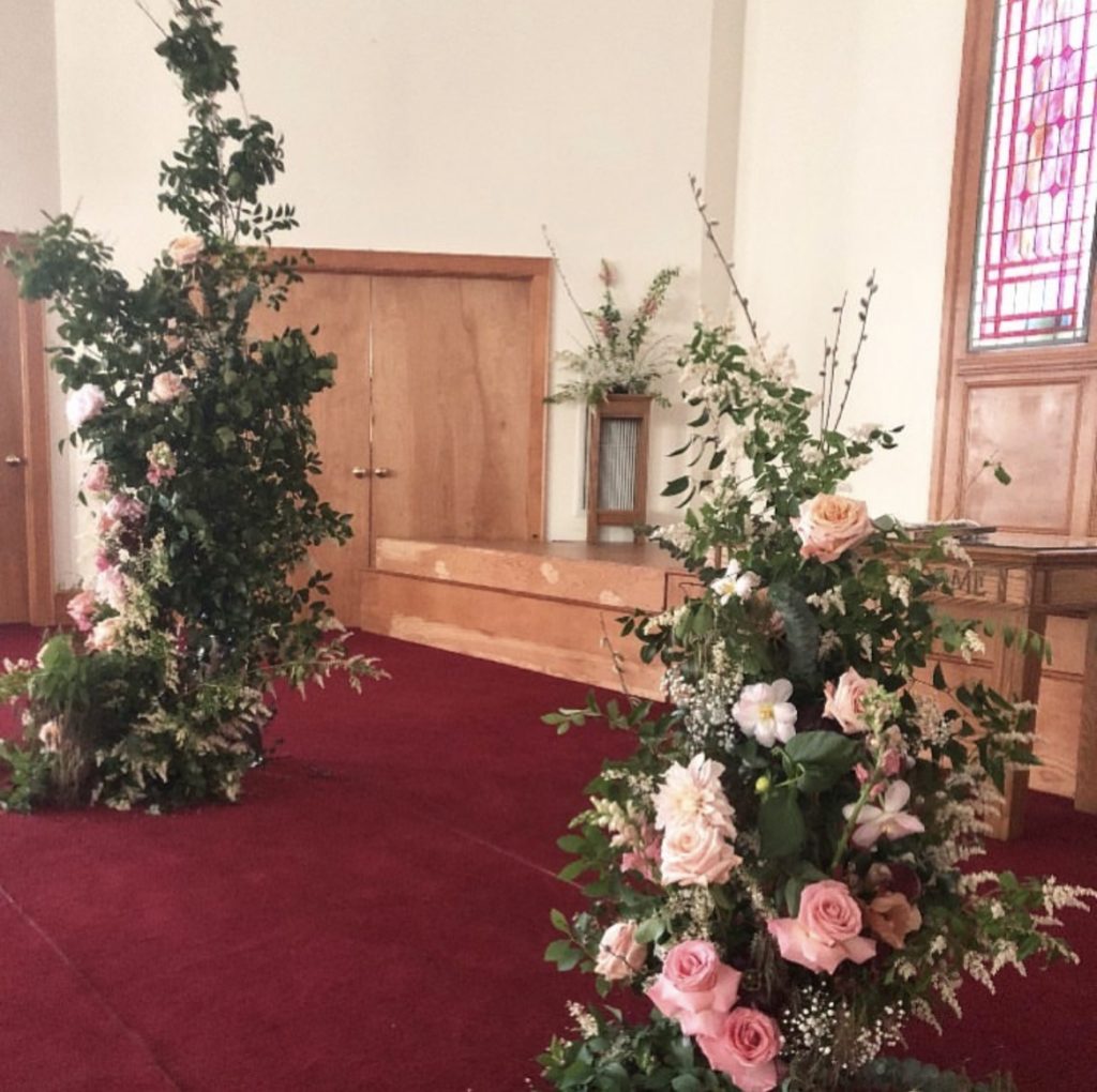 floral arrangement in church floral design by obx wedding flowers