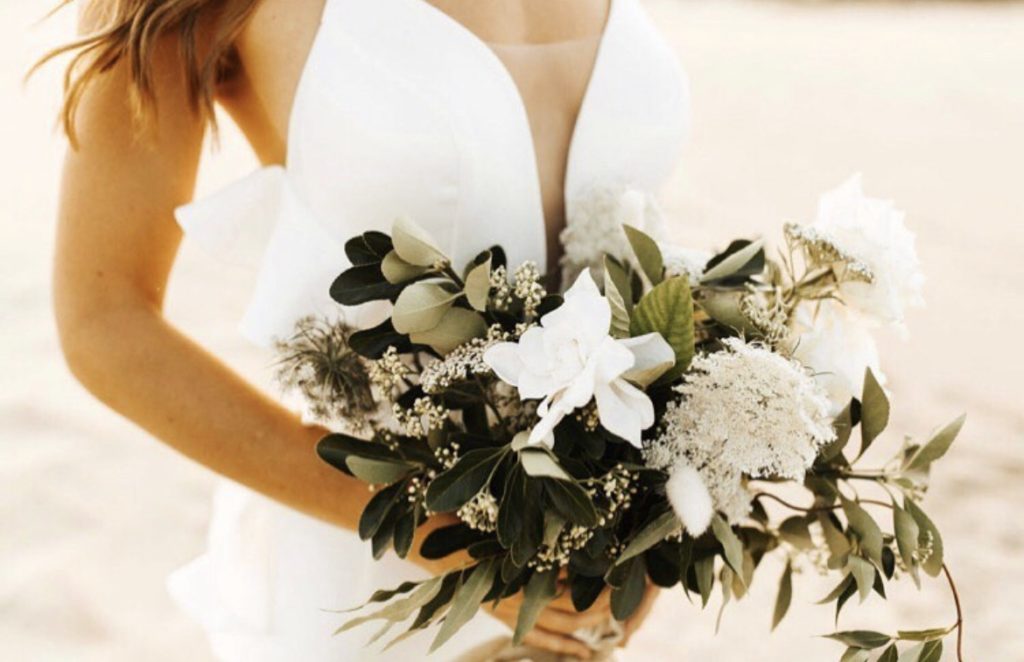 bride holding white floral bouquet obx wedding flowers beach wedding outer banks
