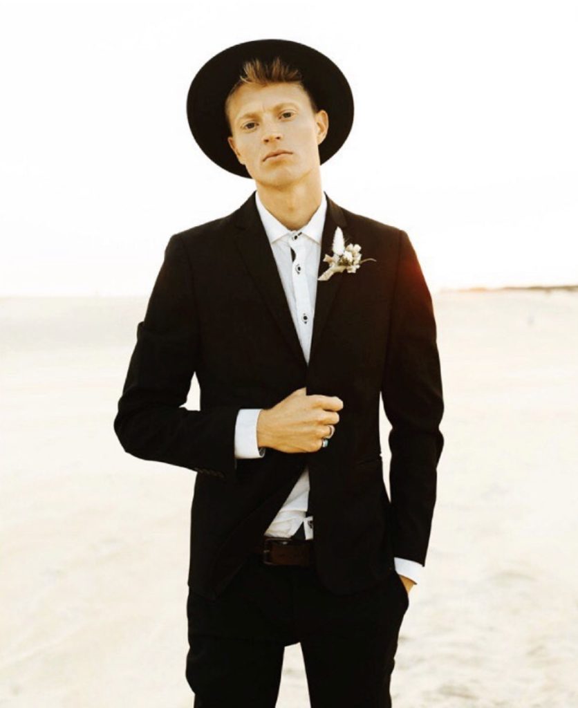 black tuxedo black hat groom with boutonniere obx wedding flowers