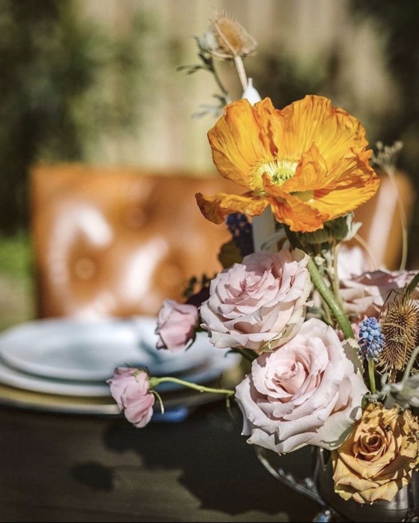 outdoor floral arrangement, orange and pink flowers with spring greenery - OBX Wedding Flowers