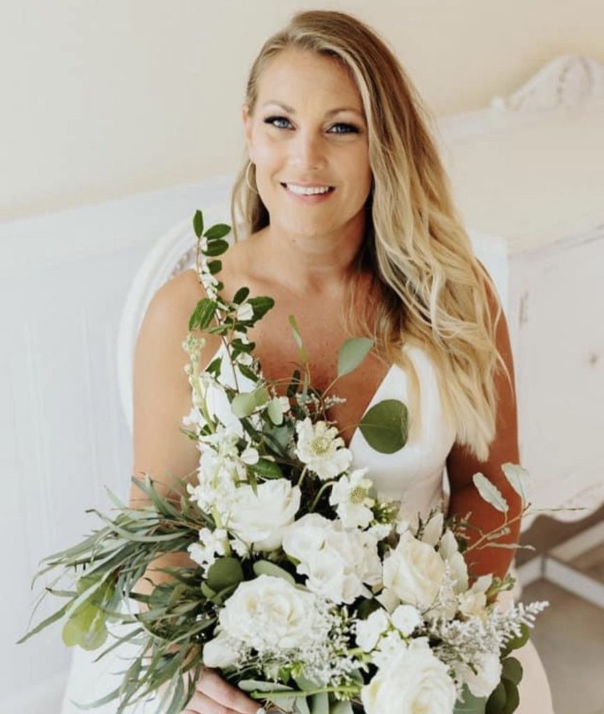 smiling blonde bride outer banks obx wedding flowers