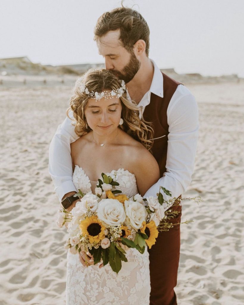 couple in embrace beach wedding outer banks north carolina obx wedding flowers