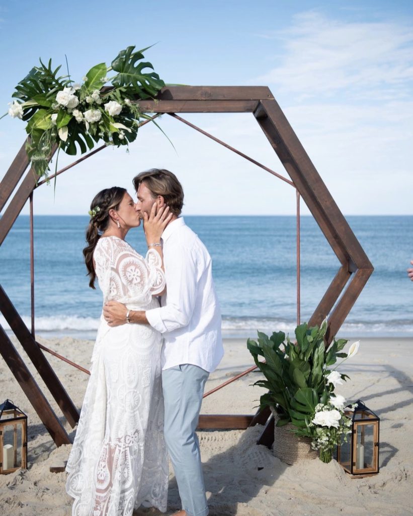 beach wedding with wooden arbor piece - floral design and arrangements by OBX Wedding Flowers