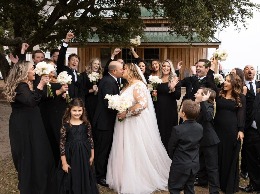 wedding happy couple kissing white flowers outdoor scene outer banks wedding obx wedding flowers, outer banks wedding flowers