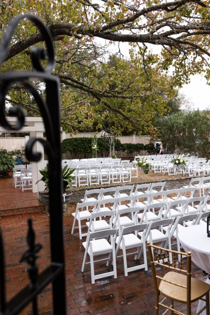 outdoor scene white chairs floral decoration by obx wedding flowers