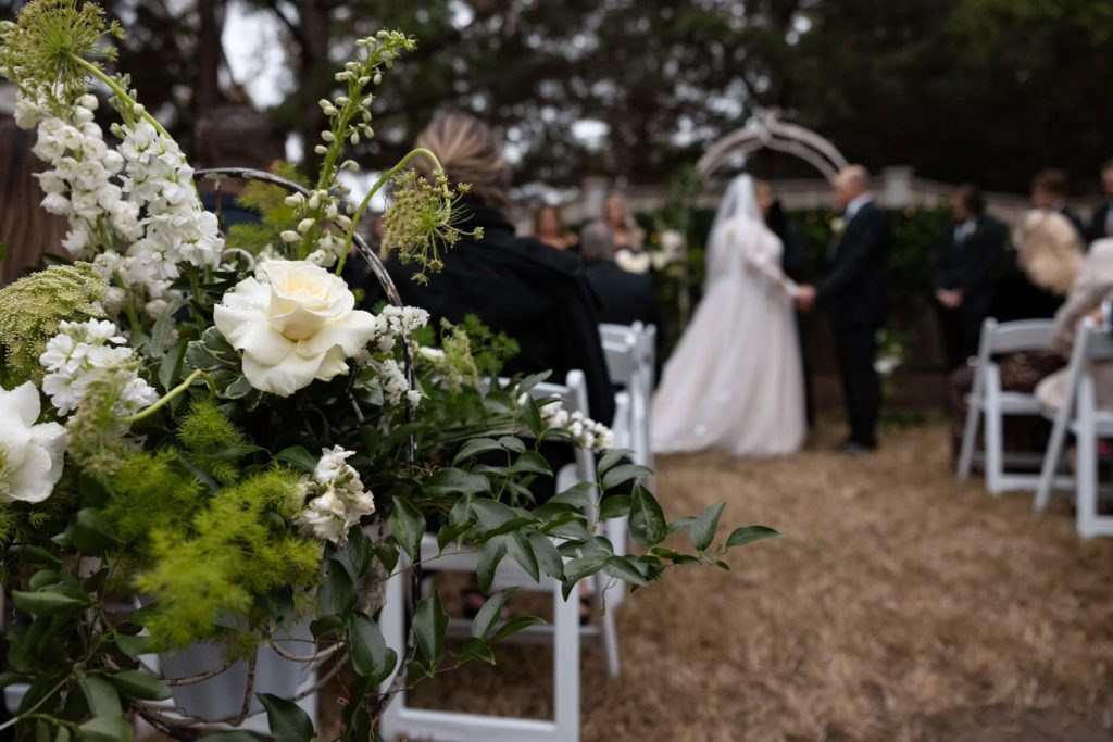 outdoor scene, wedding flowers aisle wedding decoration white chairs, outer banks, obx wedding flowers