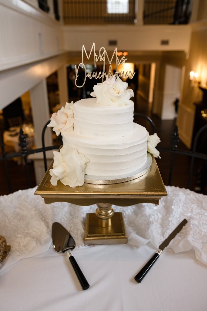 white cake with obx wedding flowers creations atop it