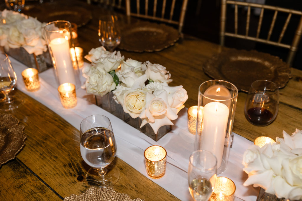 middle of table wedding flowers white flower with lit candles add romance to the wedding, obx wedding flowers