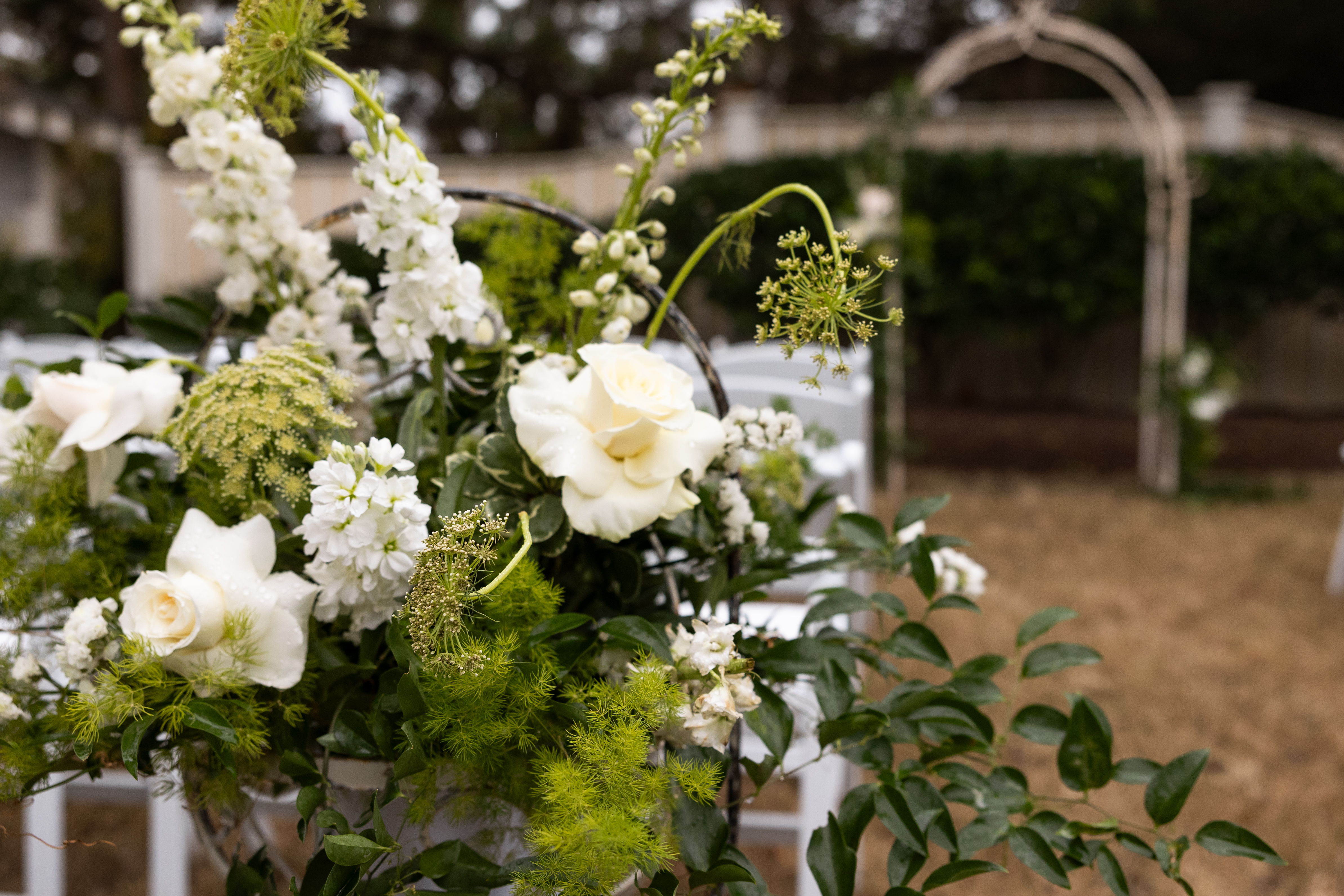 White wedding flowers on the aisle of a beautiful outer banks wedding - OBX wedding flowers