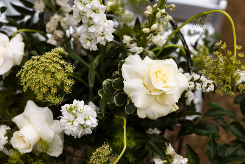 blooming white flowers line the wedding aisle of the budleigh courtyard outer banks wedding, obx wedding flowers, outer banks wedding flowers